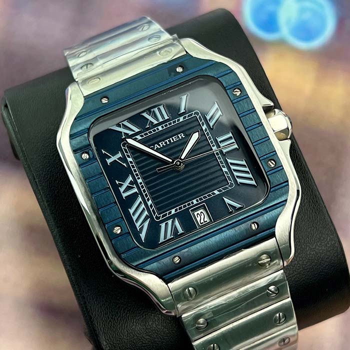 Reloj Cartier Santos azul navy con números romanos y correa en acero, ideal para hombres con estilo clásico.